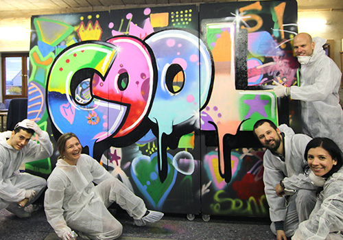 Gruppe posiert vor Graffiti